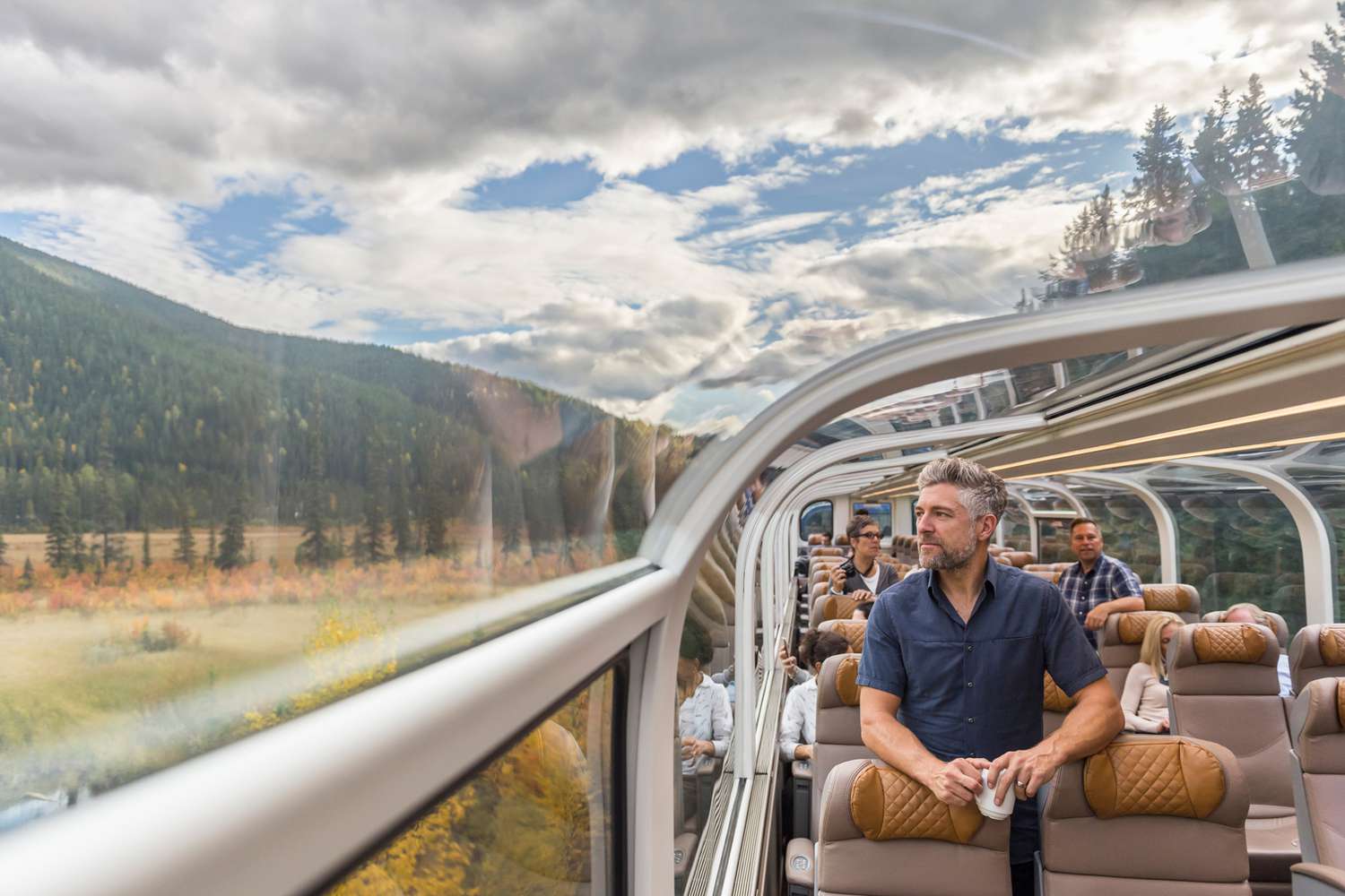 man-enjoying-scenic-journey-on-train-with-panoramic-windows