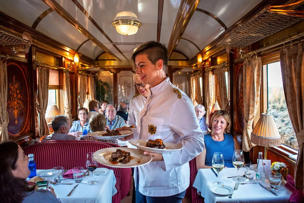 staff on spanish luxury train serving meals.